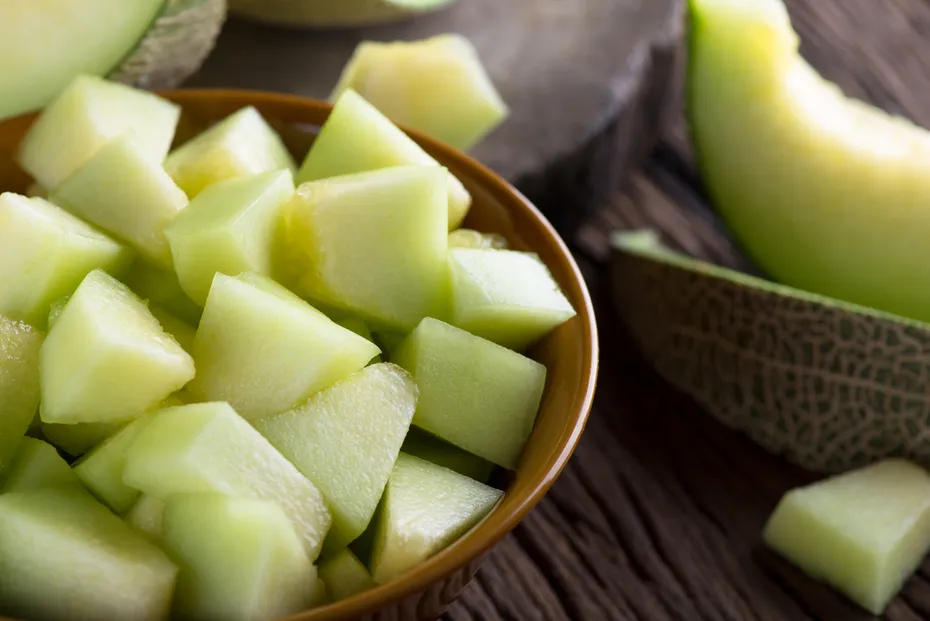 Fresh melon sliced on wooden table