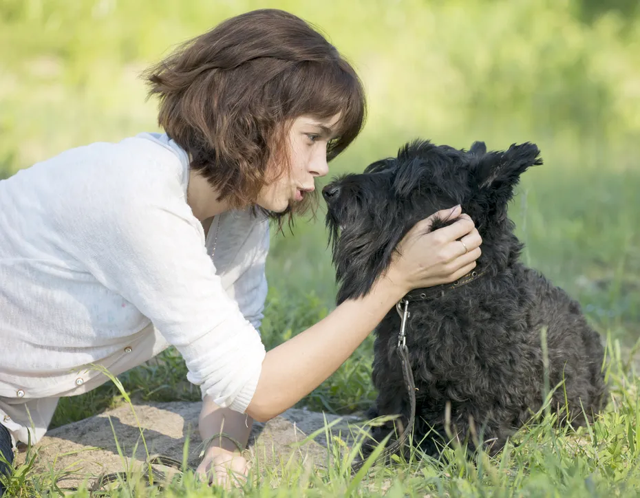 young girl talking to dog