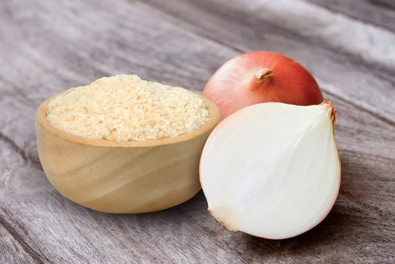 onion and powder on wooden table