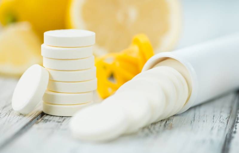 vitamin c tablets on a vintage background as detailed close up shot
