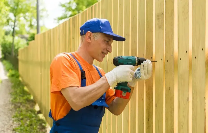 handyman building a fence