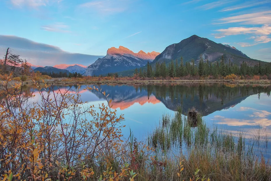 Banff, Alberta mountain range is reflected in a lake