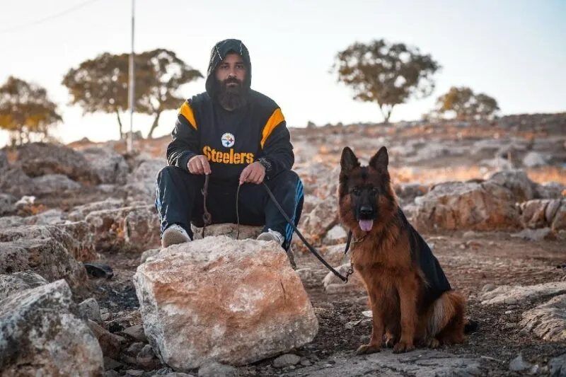 dog owner with his pet german shepherd