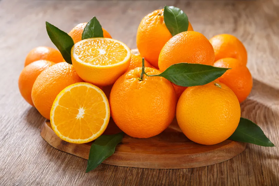 bunch of oranges on a wooden table