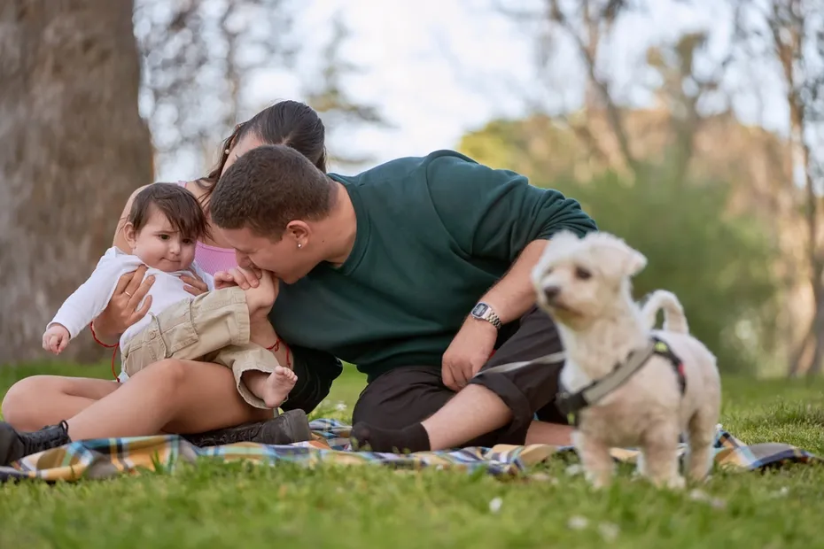 family with baby and dog out in a picnic