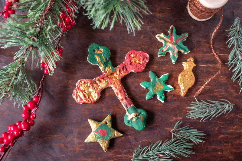 hand painted Christmas salt dough ornaments on festive wood table