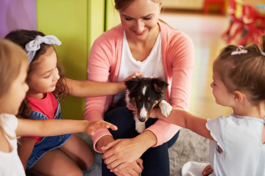 group of kids with therapy dog in a classroom