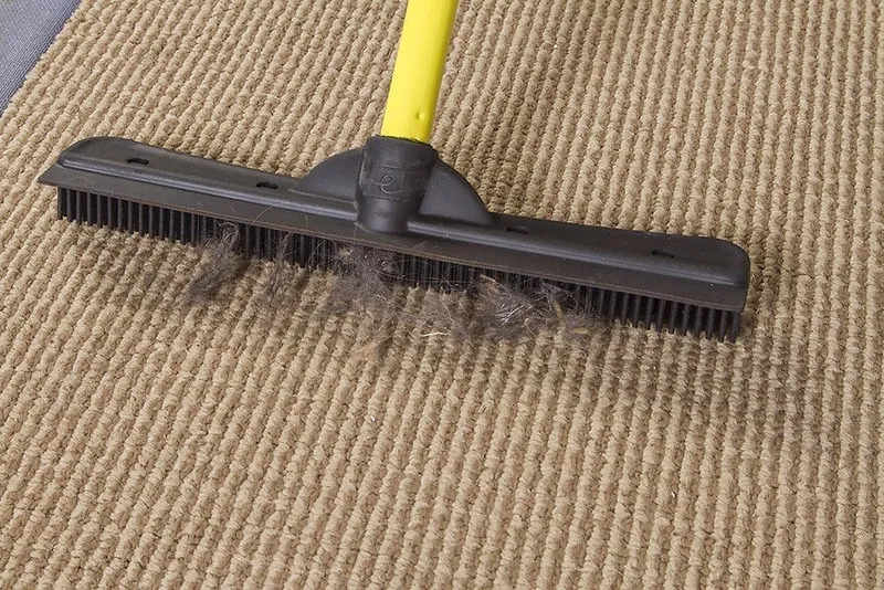 sweeping pet hair using FURemover Extendable Pet Hair Removal Broom
