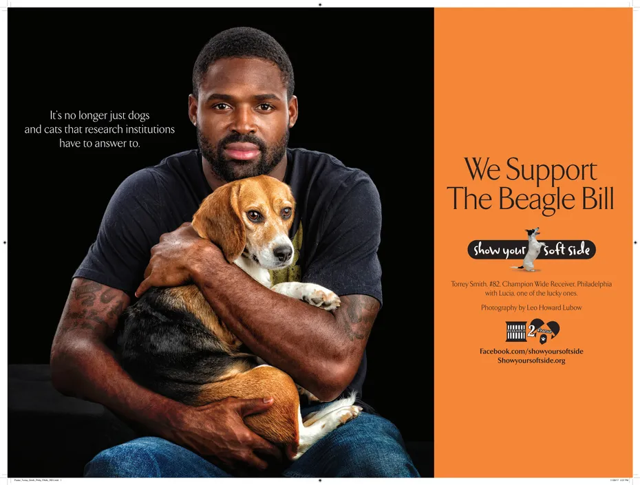 Torrey Smith holding a beagle for the Show Your Soft Side campaign