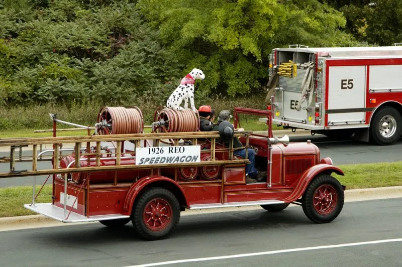 antique fire department vehicle being driven in a fire muster parade