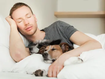 Why Does My Dog Sleep With Me? 5 Usual Reasons & Vet-Verified Considerations