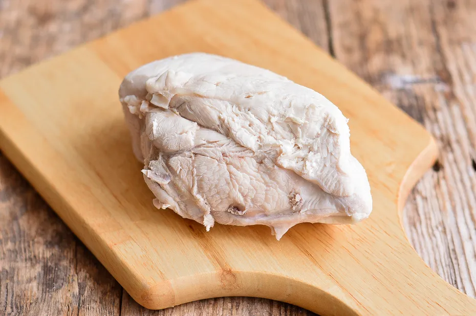 boiled chicken breast on a wooden board