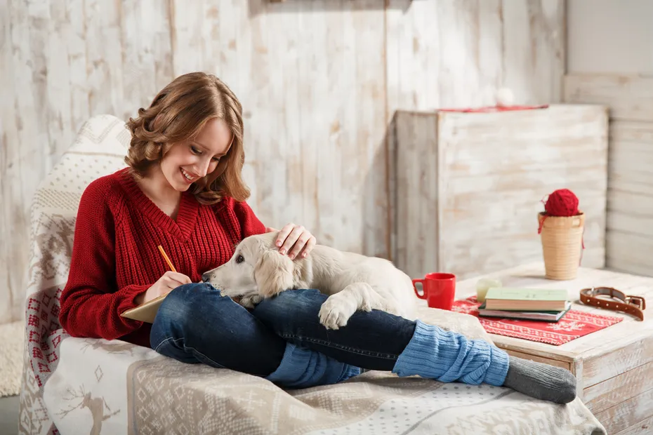 Young woman with her pet golden retriever dog relaxing together