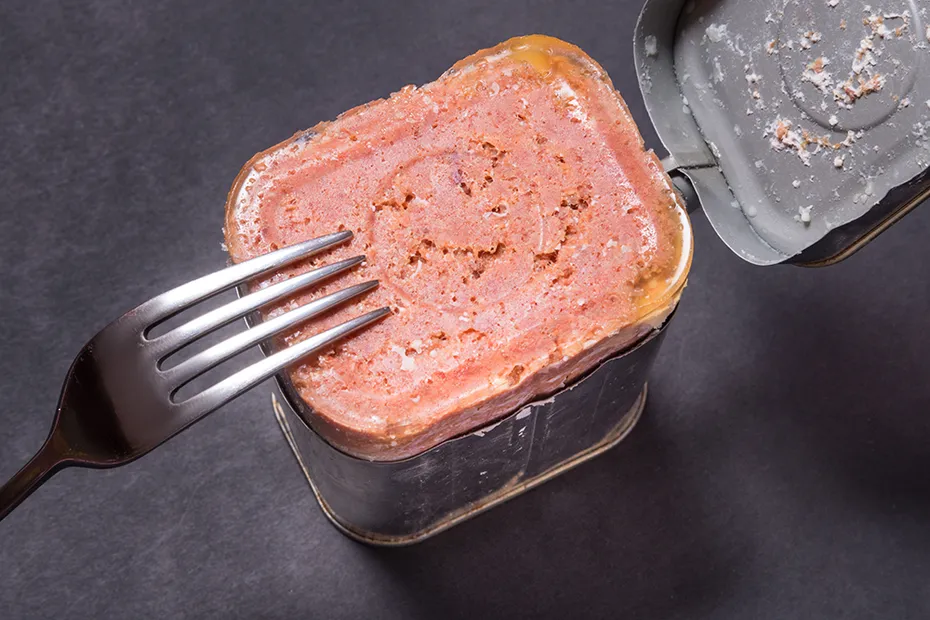 an opened can of corned beef