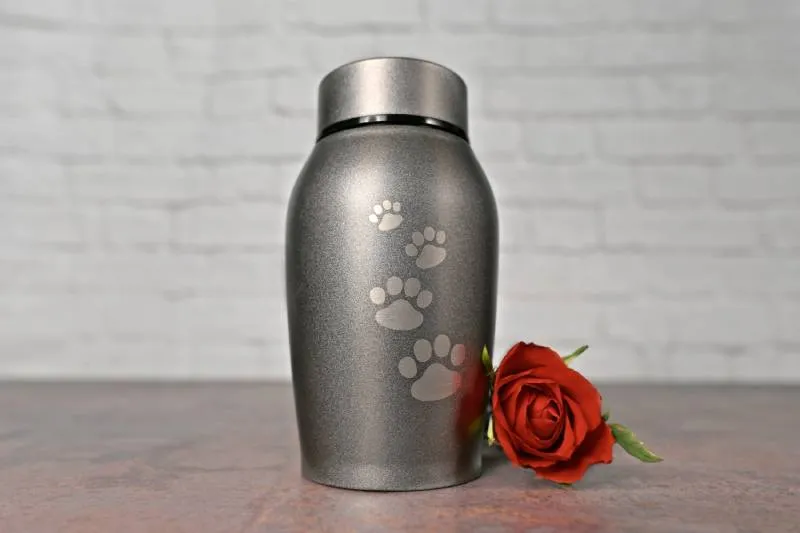 Pet urn beside a red rose