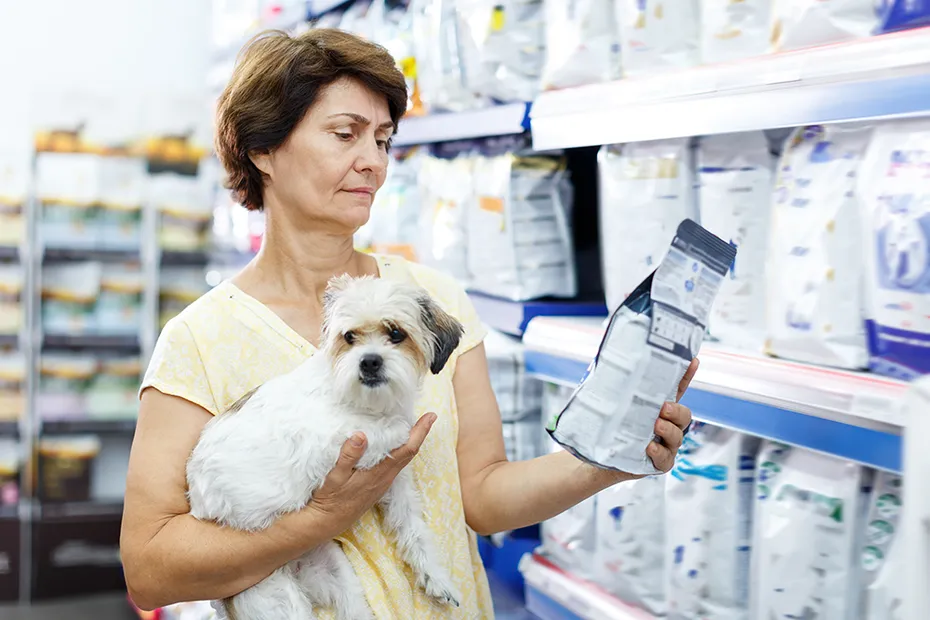 woman choosing dog food for her puppy