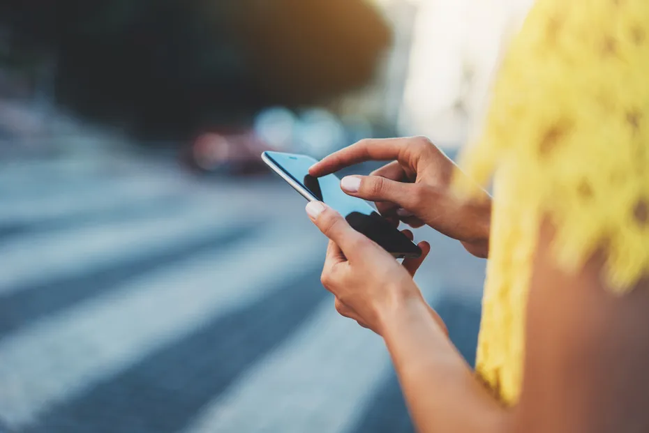 woman using her phone in the city
