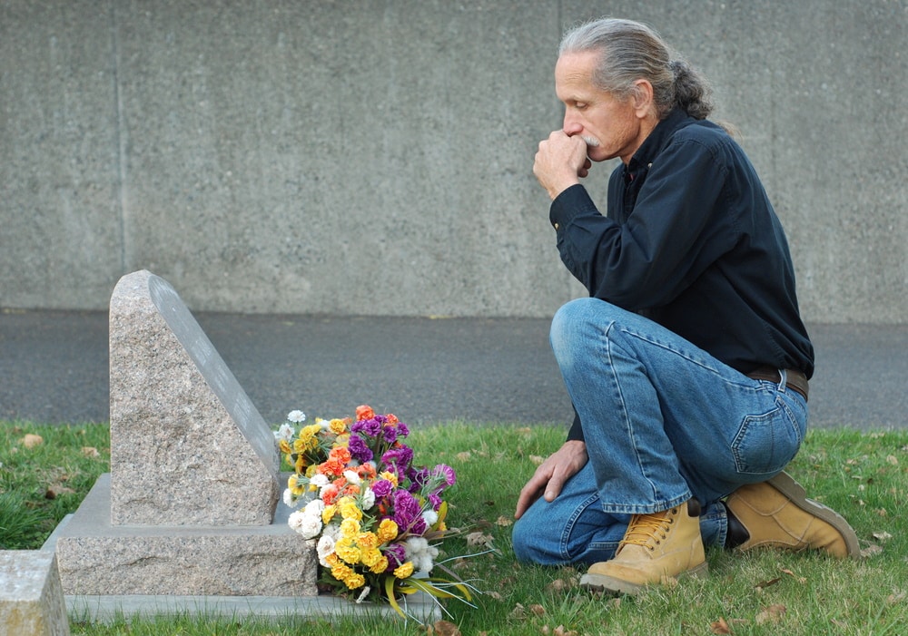 man at gravesite