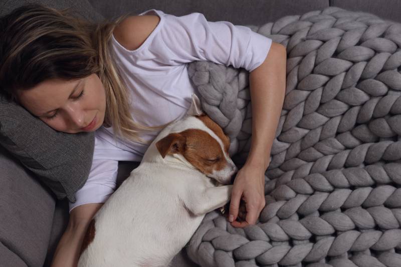 woman and dog sleeping together