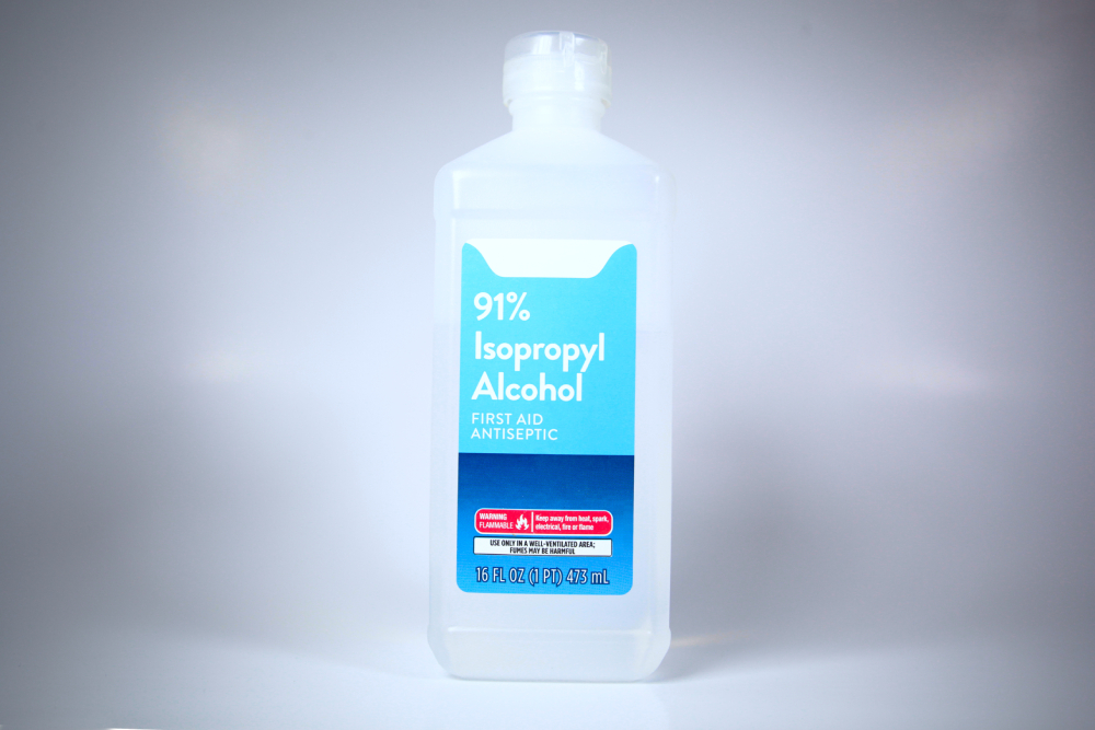 Isolated plastic bottle of 91% isopropyl alcohol with label
