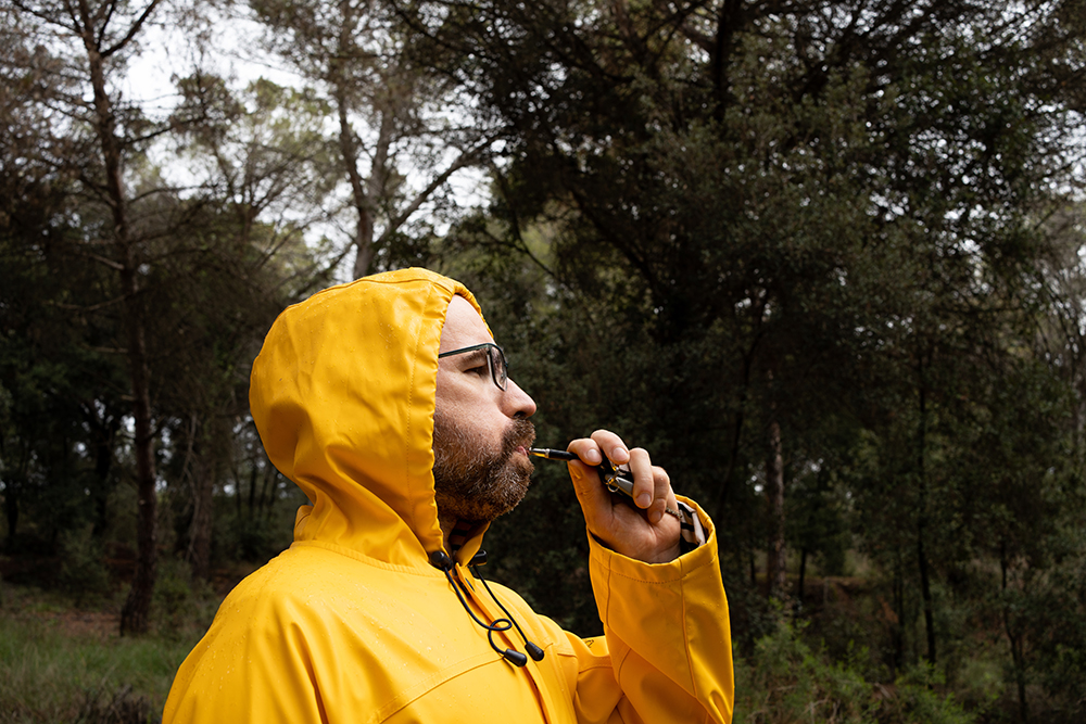 man using dog whistle in the middle of the forest