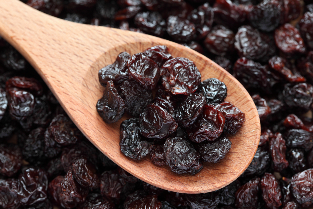 Raisins in a wooden spoon