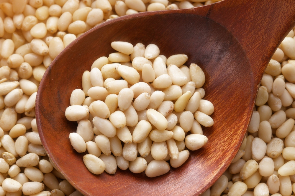 cleaned pine nuts in a spoon