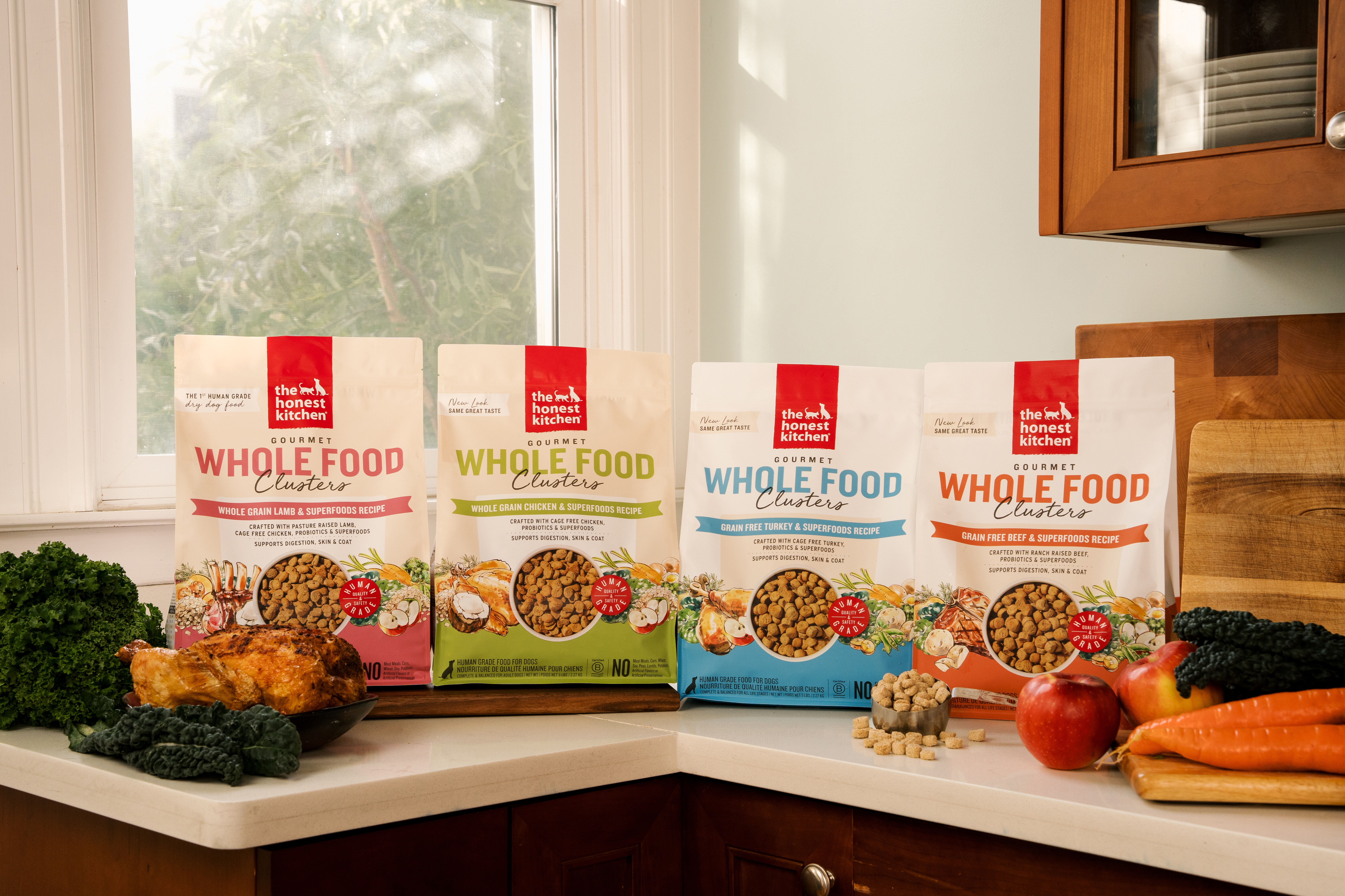 Four bags of The Honest Kitchen Whole Food Clusters dog food on a counter